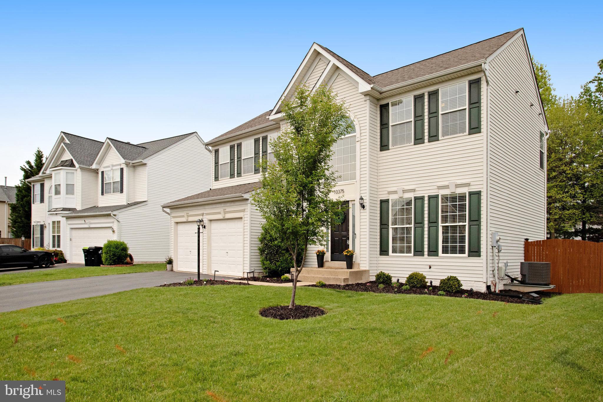10375 Navarone Place Manassas, VA 20110 - Photo 3 of 51 a front view of a house with a yard