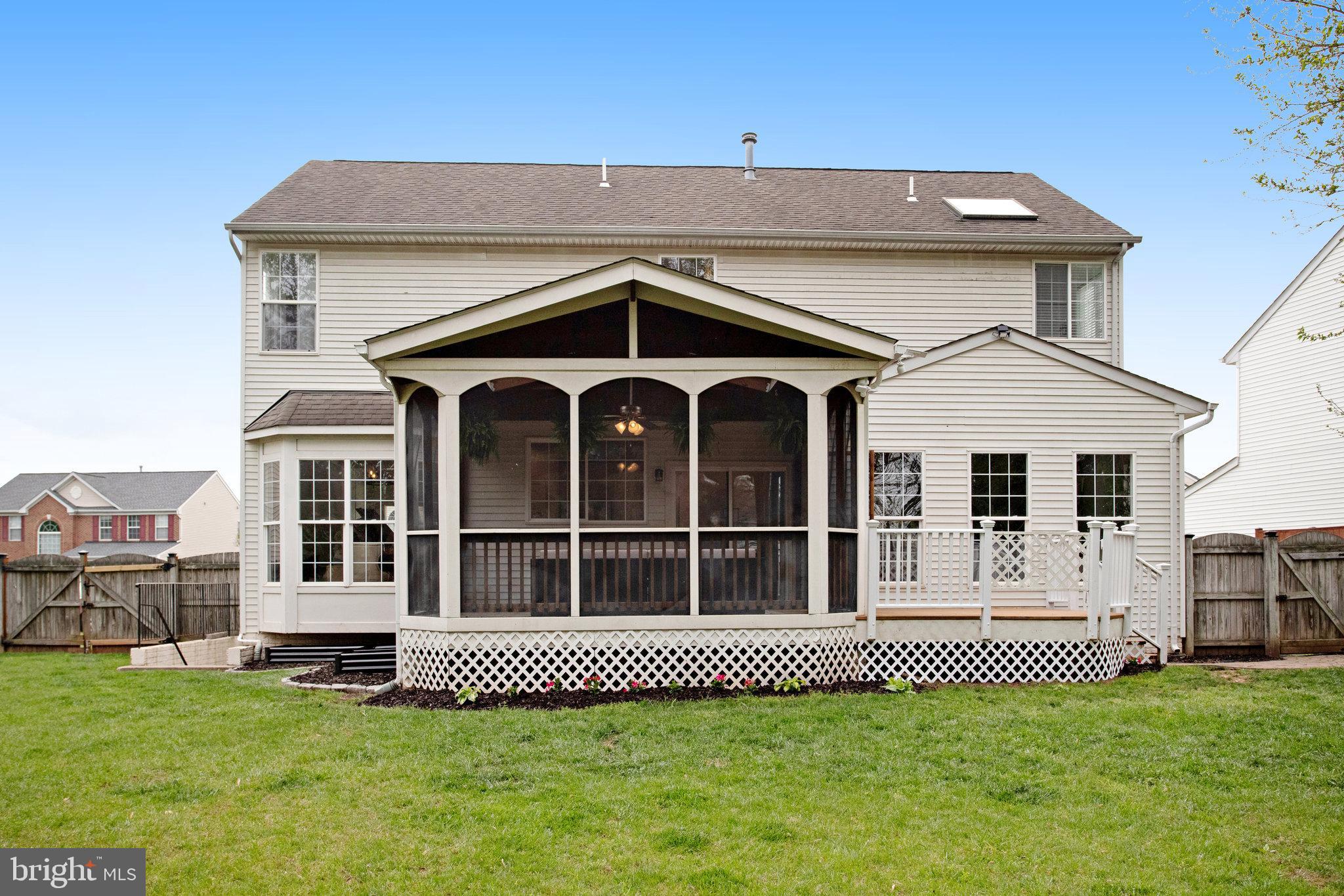 10375 Navarone Place Manassas, VA 20110 - Photo 45 of 51 a front view of a house with a garden