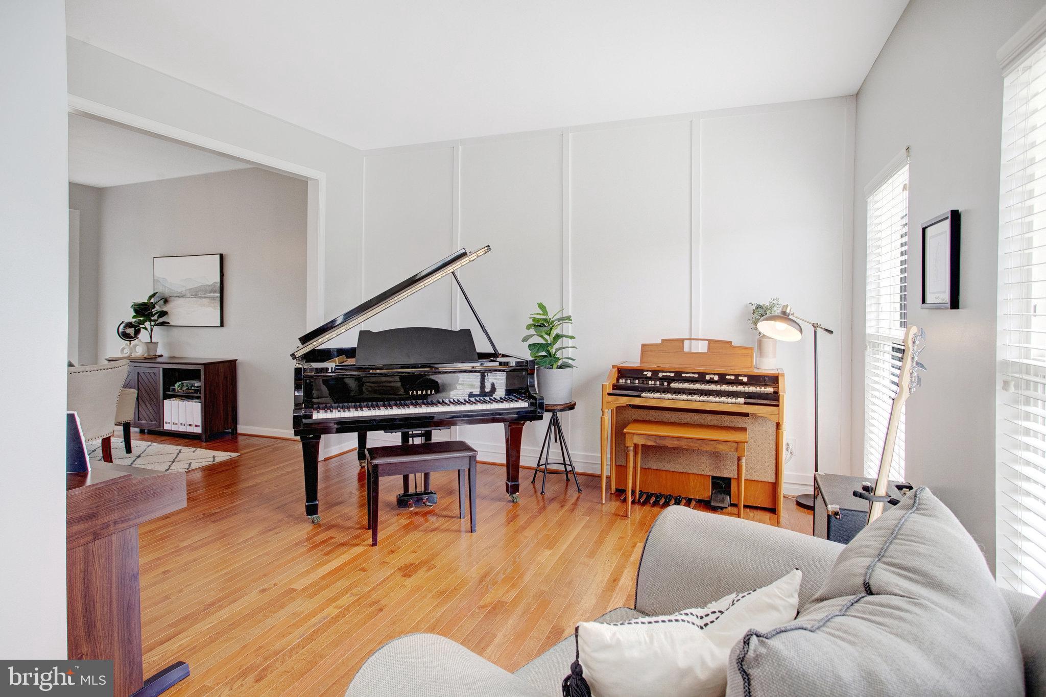 10375 Navarone Place Manassas, VA 20110 - Photo 5 of 51 a living room with furniture a piano and wooden floor