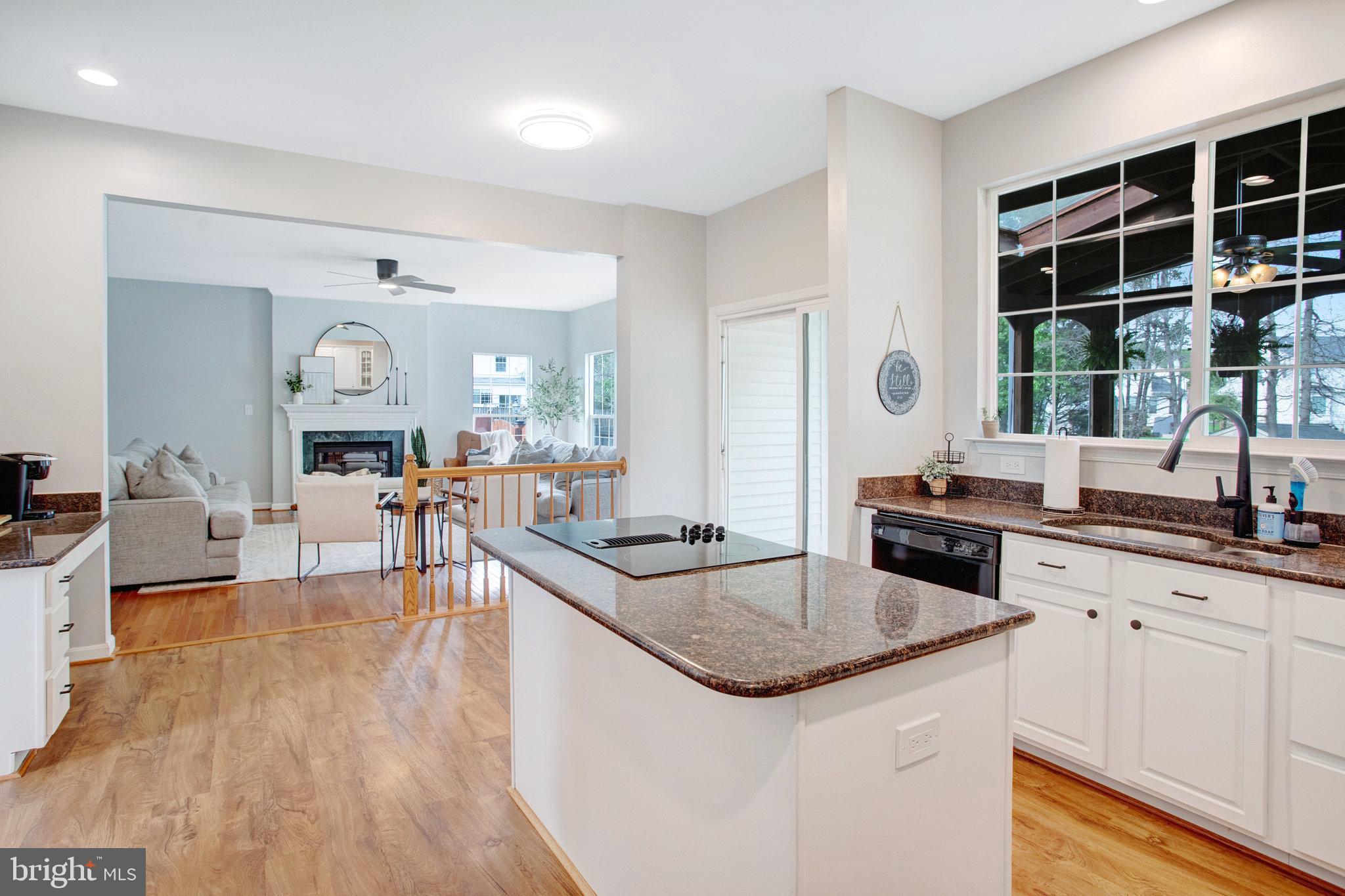 10375 Navarone Place Manassas, VA 20110 - Photo 9 of 51 a kitchen with granite countertop a sink and a stove top oven