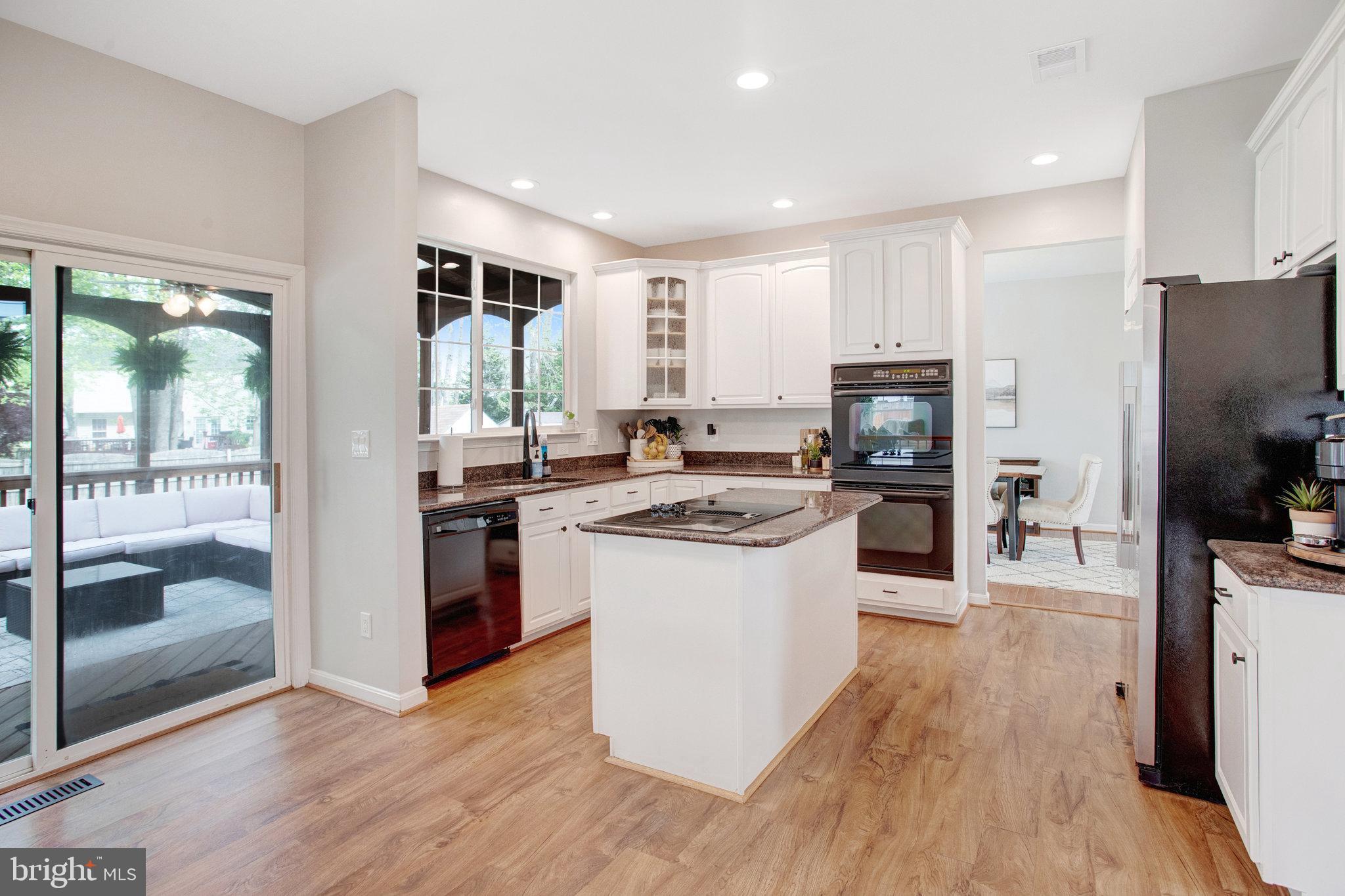 10375 Navarone Place Manassas, VA 20110 - Photo 10 of 51 a kitchen with stainless steel appliances a stove top oven and a refrigerator