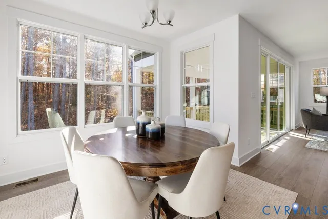 a view of a dining room with furniture wooden floor and a chandelier