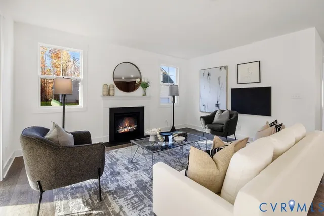 a living room with furniture a fireplace and a flat screen tv