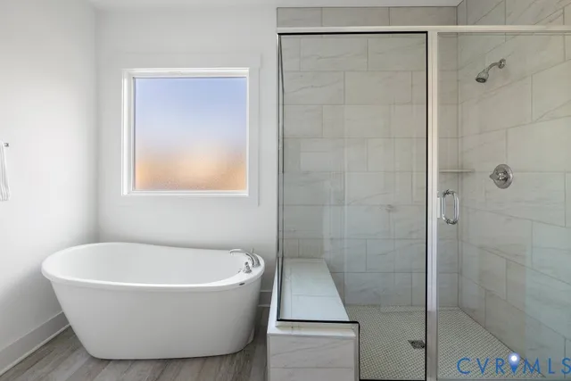 a bathroom with a bathtub and shower