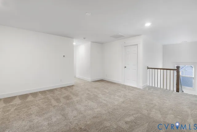 a view of a room with wooden floor and windows