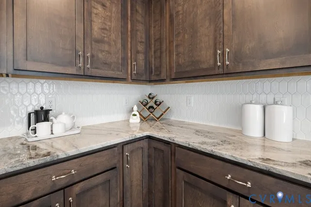 a kitchen with granite countertop cabinets and white stainless steel appliances
