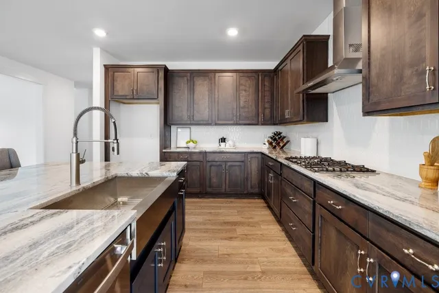 a kitchen with kitchen island granite countertop a sink stainless steel appliances and cabinets