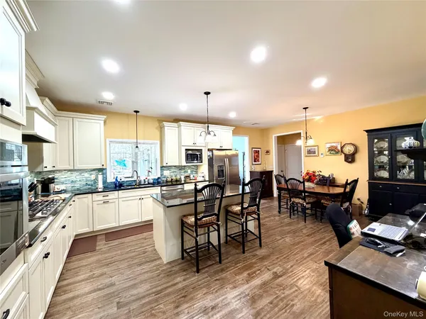 a kitchen with lots of counter top space and furniture