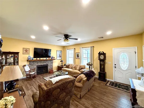a living room with furniture a flat screen tv and a fireplace