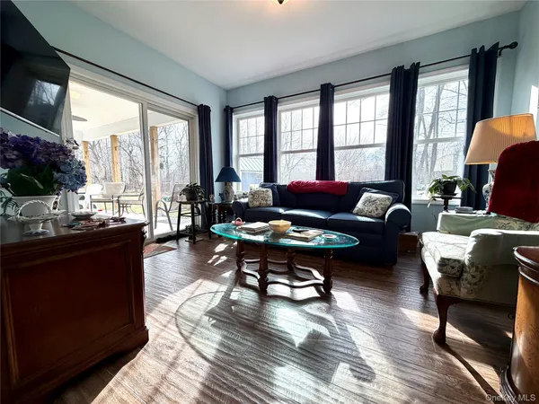 a living room with furniture and a floor to ceiling window