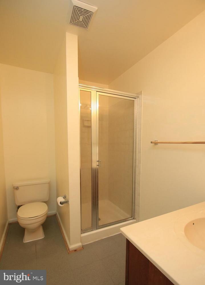 6323 Millwood Circle Springfield, VA 22152 - Photo 17 of 20 a bathroom with a granite countertop sink toilet and shower