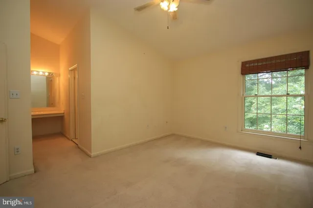 an empty room with a empty space and windows