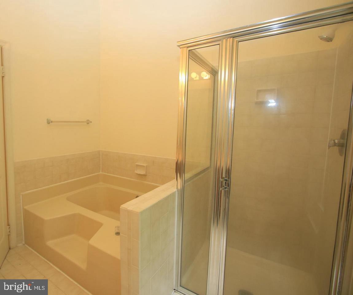 6323 Millwood Circle Springfield, VA 22152 - Photo 10 of 20 a bathroom with a glass shower door