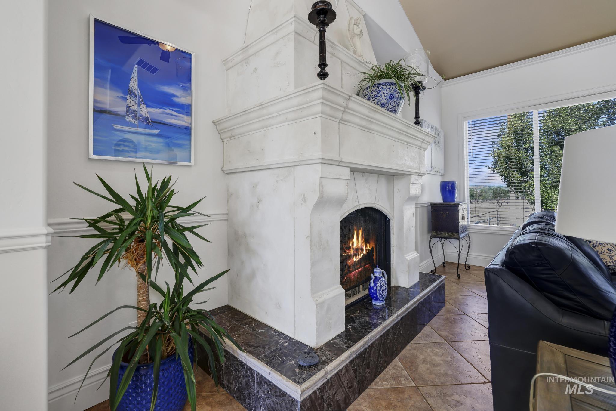 1301 Kanaka Rapids Road Buhl, ID 83316 - Photo 31 of 50 Fireplace featuring a substantial mantel, dark stone hearth, and decorative base trim