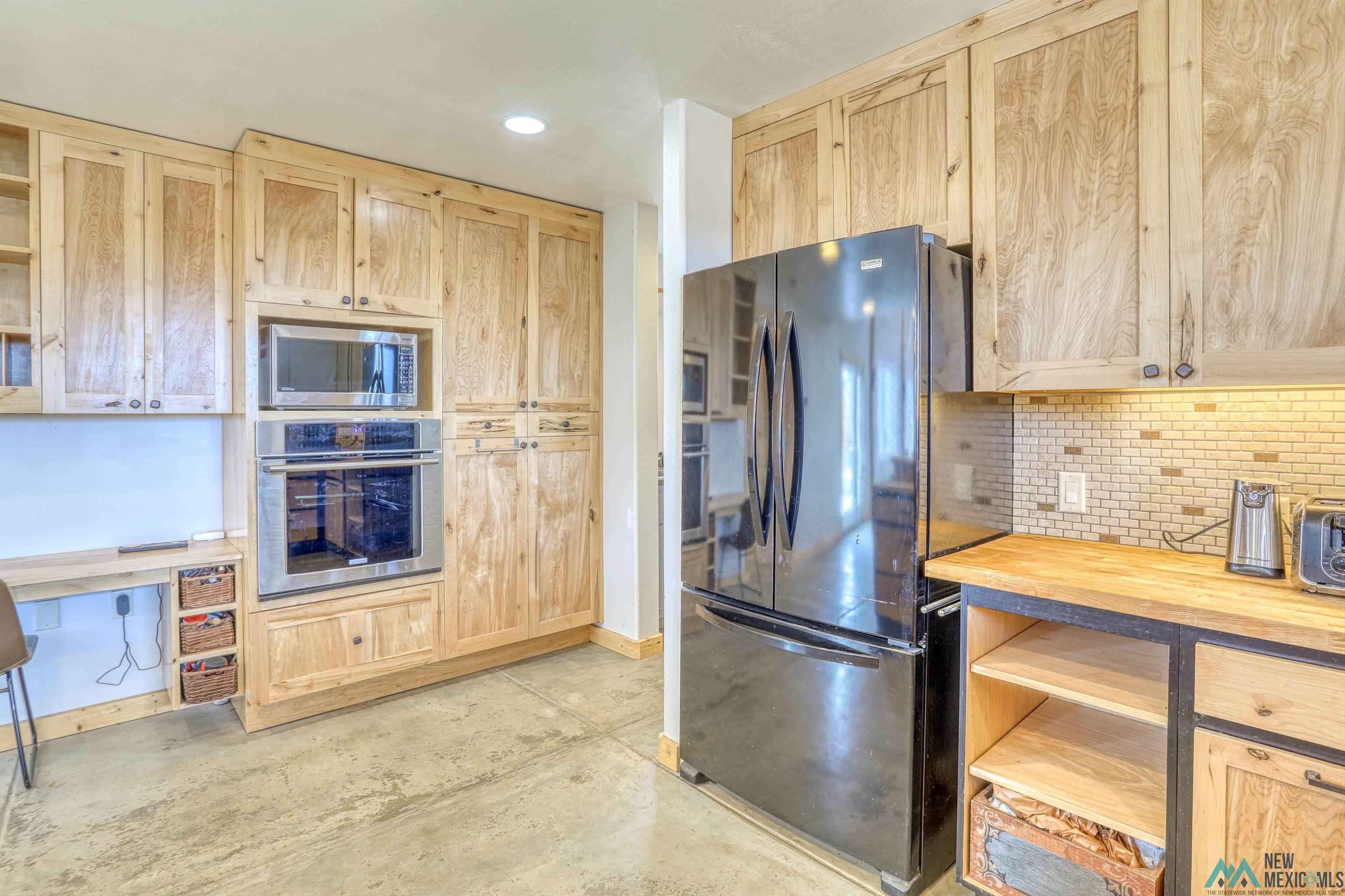12 Horn Toad Road Chama, NM 87520 - Photo 21 of 52 Kitchen featuring light brown cabinets, appliances with stainless steel finishes, butcher block counters, open shelves, and recessed lighting
