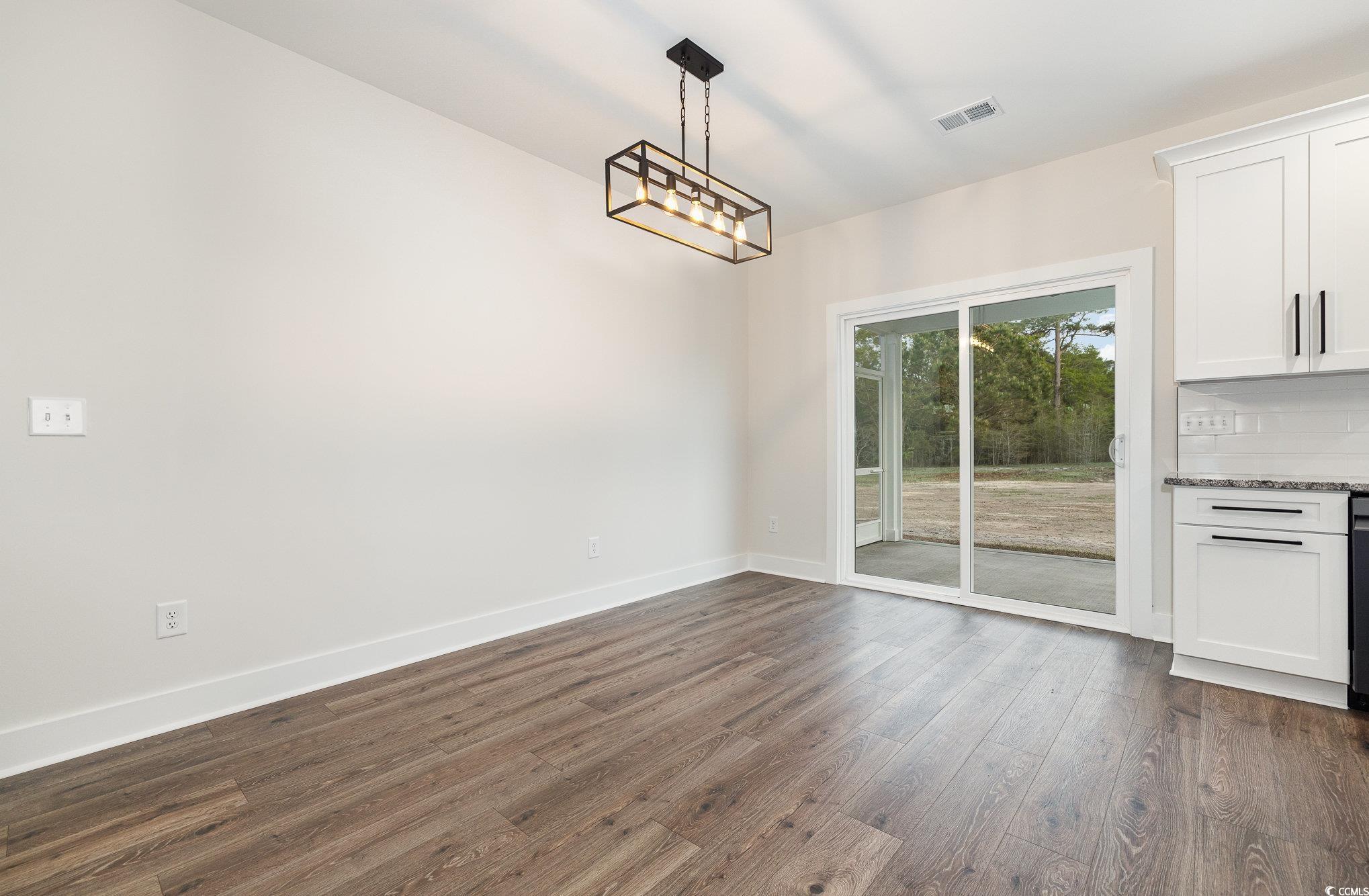 983 Pisgah Church Road Aynor, SC 29511 - Photo 17 of 37 Unfurnished dining area with baseboards, dark wood