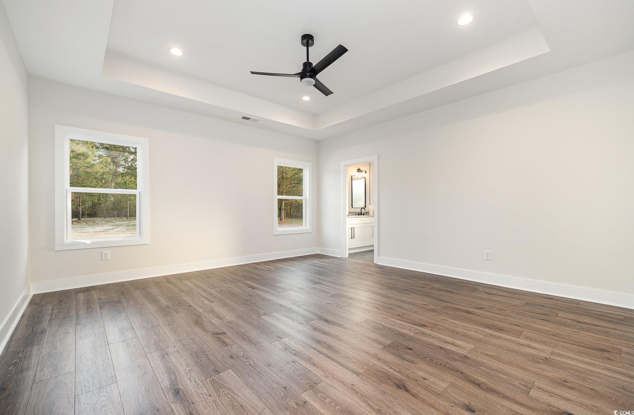 983 Pisgah Church Road Aynor, SC 29511 - Photo 19 of 37 Empty room with a tray ceiling, baseboards, dark w