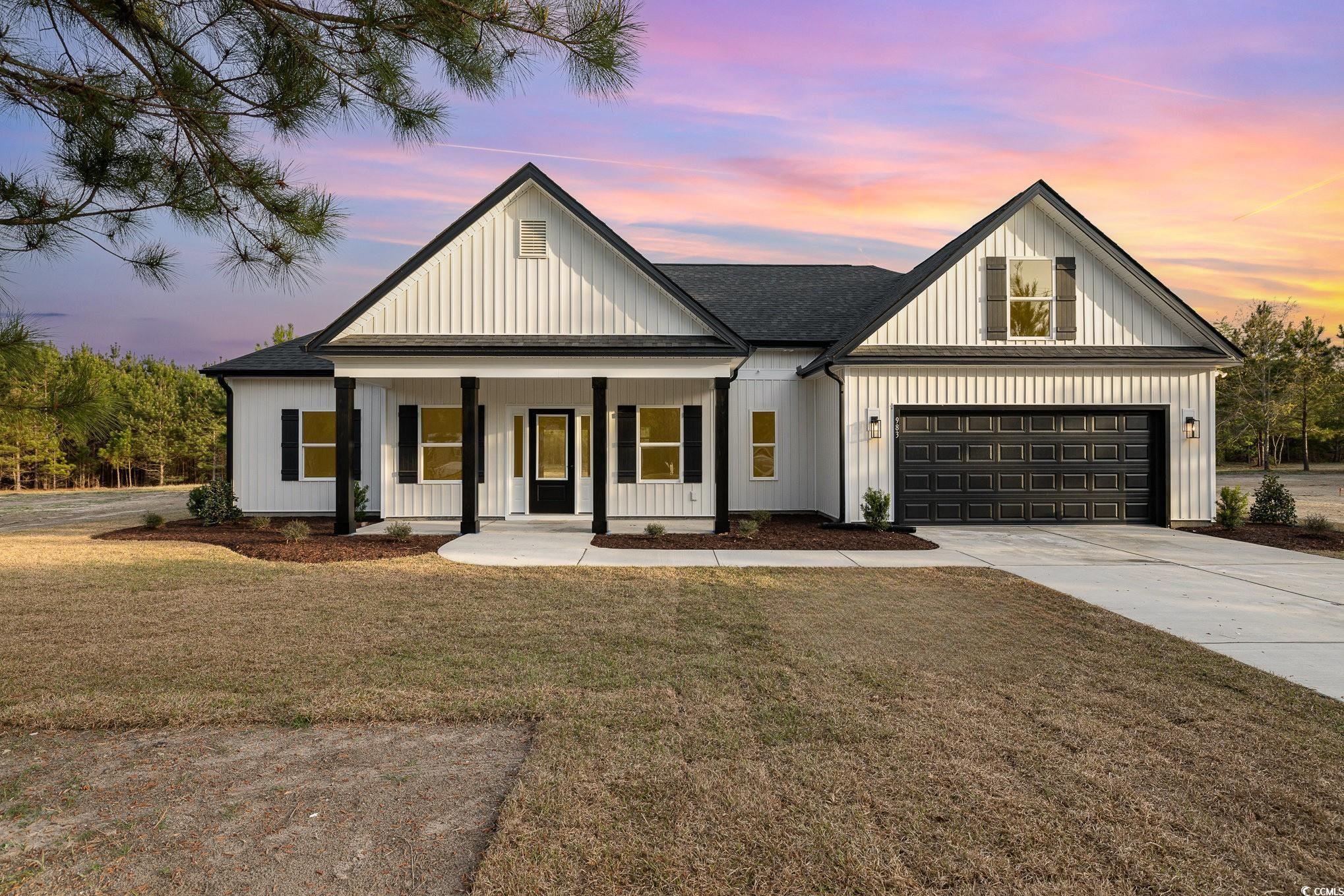 Modern farmhouse style home with concrete driveway