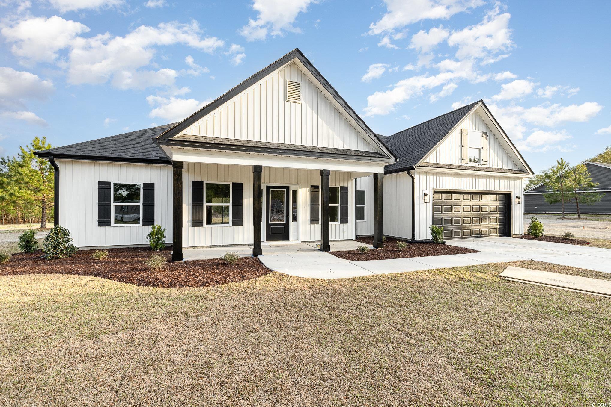 Modern inspired farmhouse featuring covered porch,