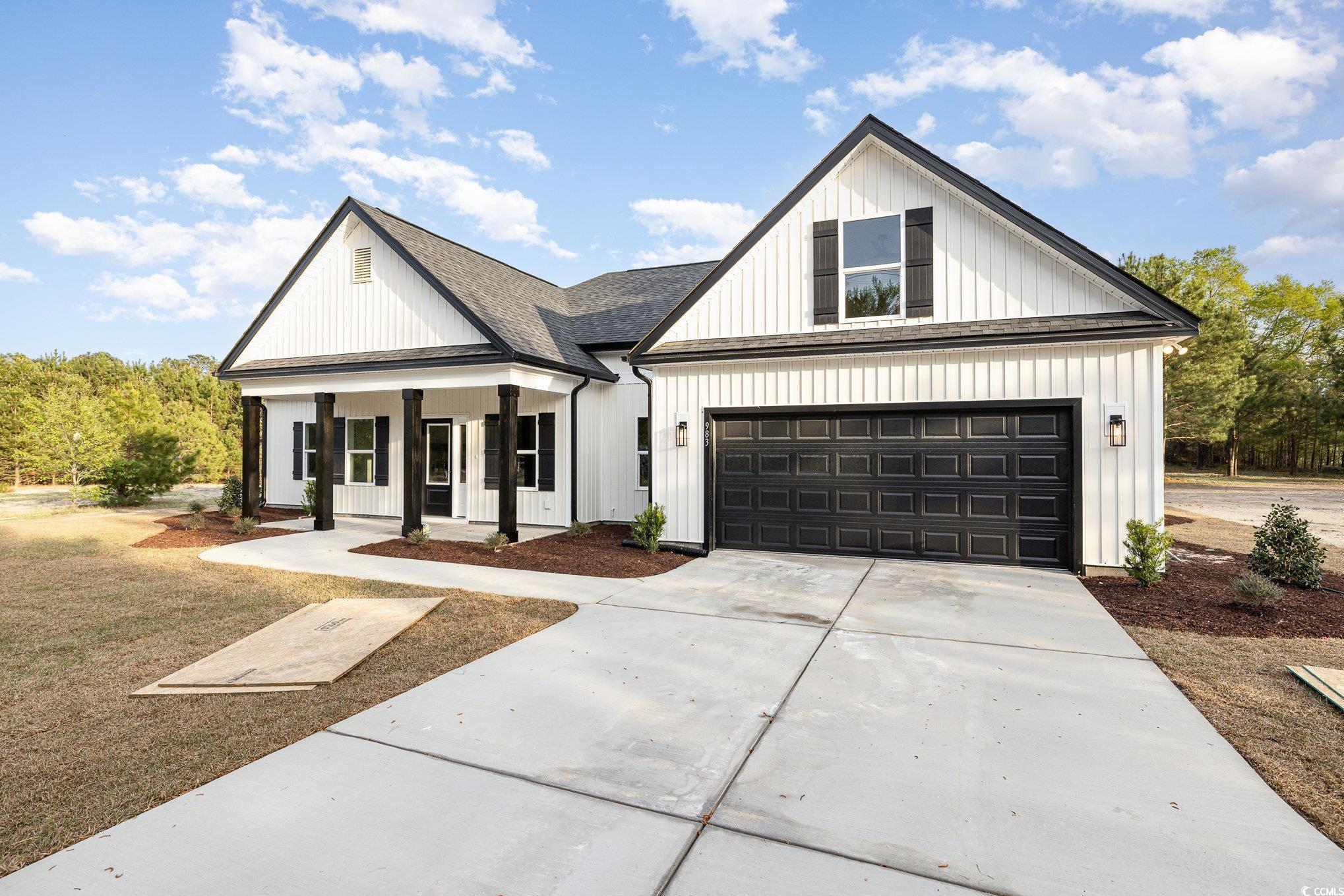 Modern inspired farmhouse featuring roof with shin