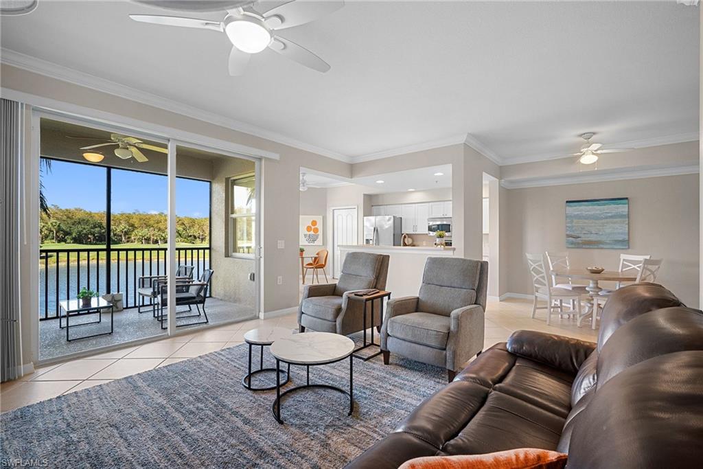 10265 Heritage Bay Boulevard, Unit 622 Naples, FL 34120 - Photo 11 of 50 a living room with furniture and a large window