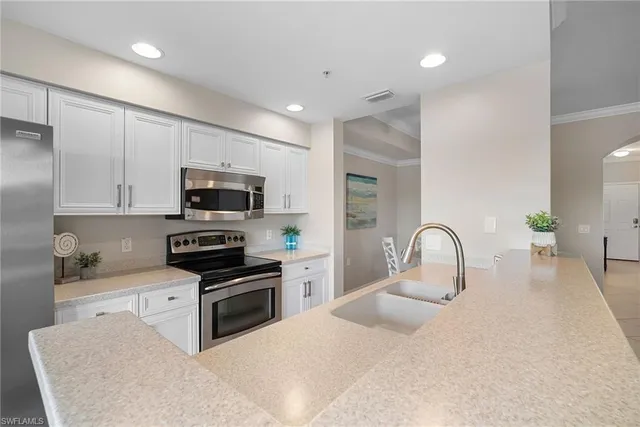 a kitchen with a sink a table and chairs