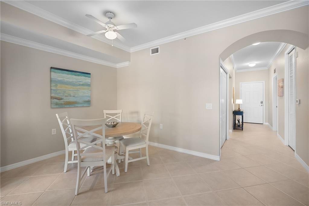 10265 Heritage Bay Boulevard, Unit 622 Naples, FL 34120 - Photo 21 of 50 a view of a dining room with furniture and chandelier fan