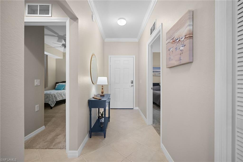 10265 Heritage Bay Boulevard, Unit 622 Naples, FL 34120 - Photo 22 of 50 view of hall way with mirror