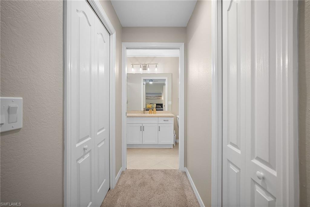 10265 Heritage Bay Boulevard, Unit 622 Naples, FL 34120 - Photo 25 of 50 a bathroom with a sink and a mirror