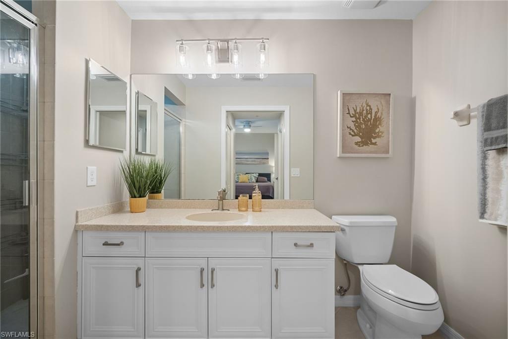 10265 Heritage Bay Boulevard, Unit 622 Naples, FL 34120 - Photo 26 of 50 a bathroom with a sink vanity mirror and toilet