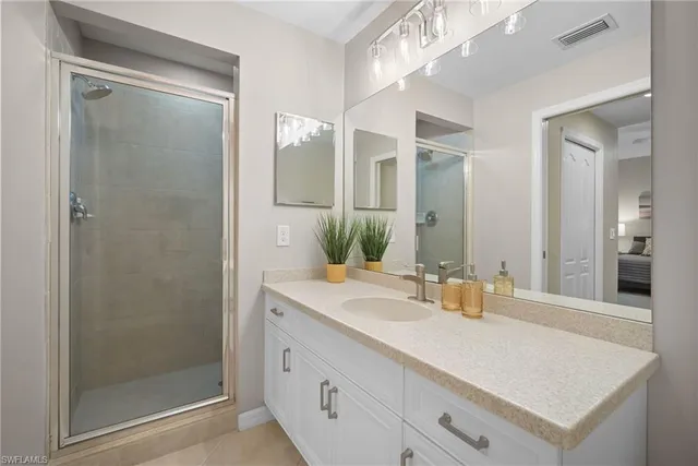 a bedroom with two beds and a chandelier