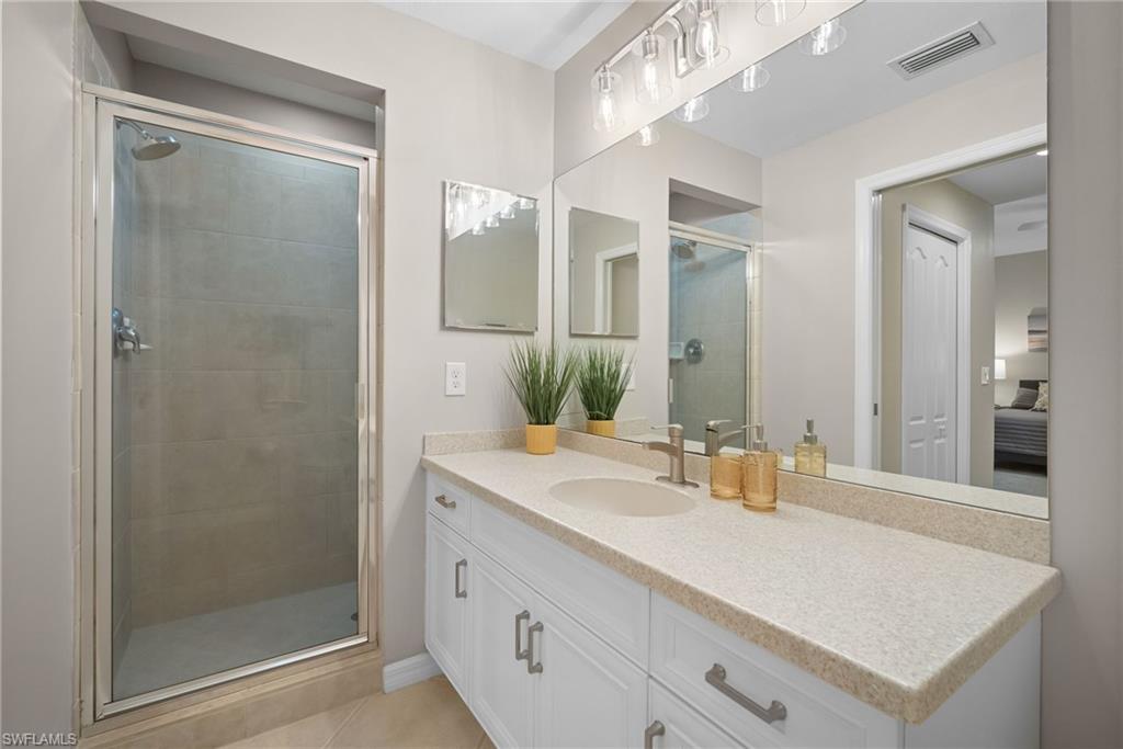 10265 Heritage Bay Boulevard, Unit 622 Naples, FL 34120 - Photo 27 of 50 a bathroom with a sink and a mirror