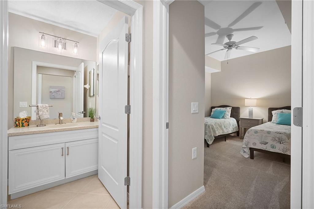 10265 Heritage Bay Boulevard, Unit 622 Naples, FL 34120 - Photo 29 of 50 a en suite bathroom with 2 sink and a mirror