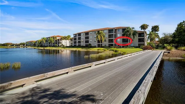 a view of swimming pool with outdoor seating and lake view