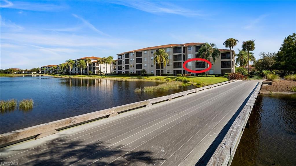 10265 Heritage Bay Boulevard, Unit 622 Naples, FL 34120 - Photo 3 of 50 a view of swimming pool with outdoor seating and lake view