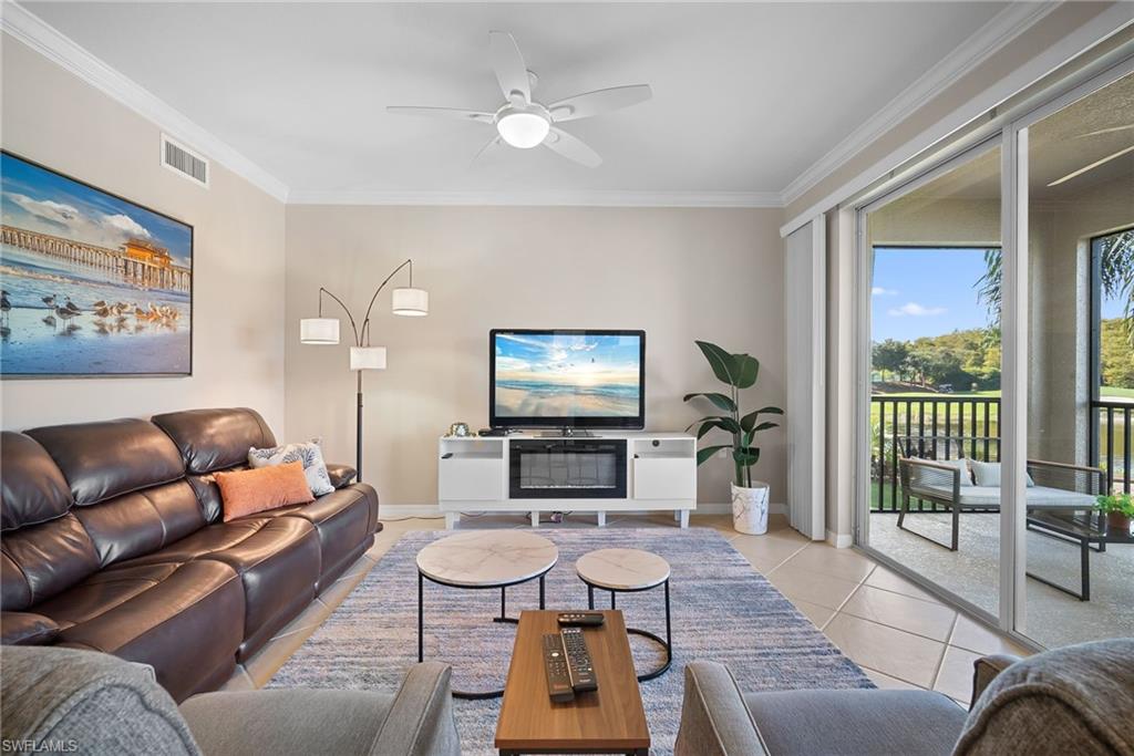 10265 Heritage Bay Boulevard, Unit 622 Naples, FL 34120 - Photo 9 of 50 a living room with furniture and a flat screen tv