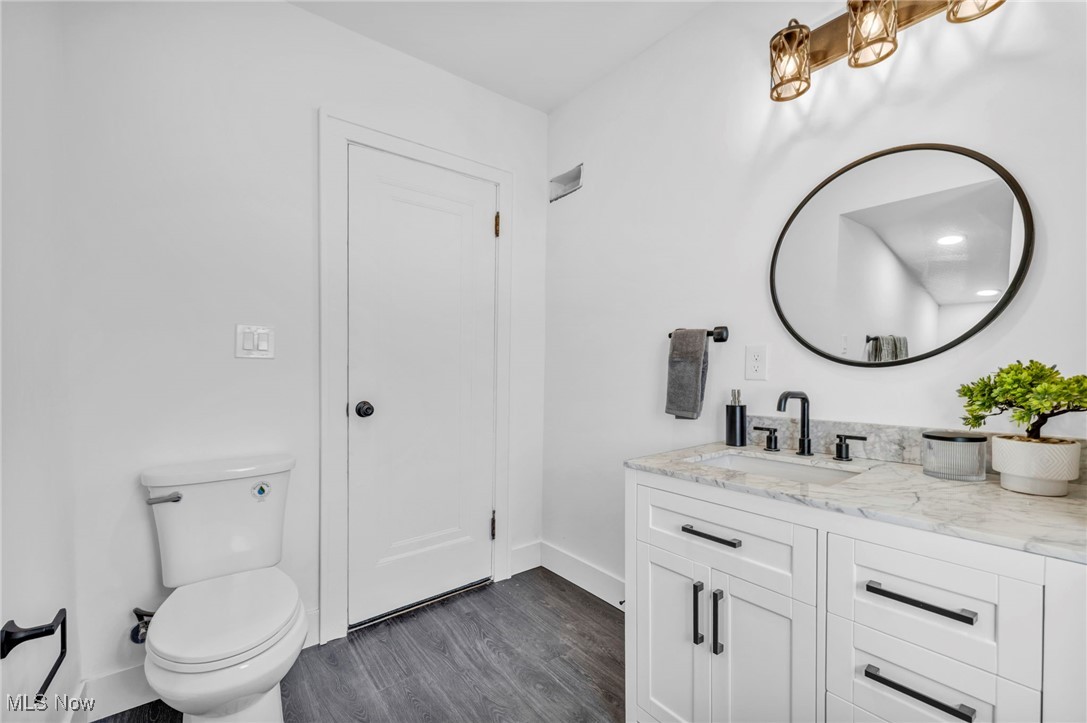 2128 Hampstead Road Cleveland Heights, OH 44118 - Photo 15 of 32 Half bathroom with dark wood-style floors and vanity