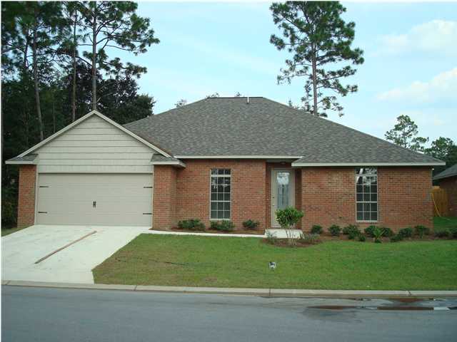 4618 Hermosa Road Crestview, FL 32539 - Photo 1 of 9 a front view of a house with a yard and garage