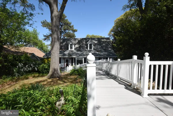 a view of a house with wooden fence