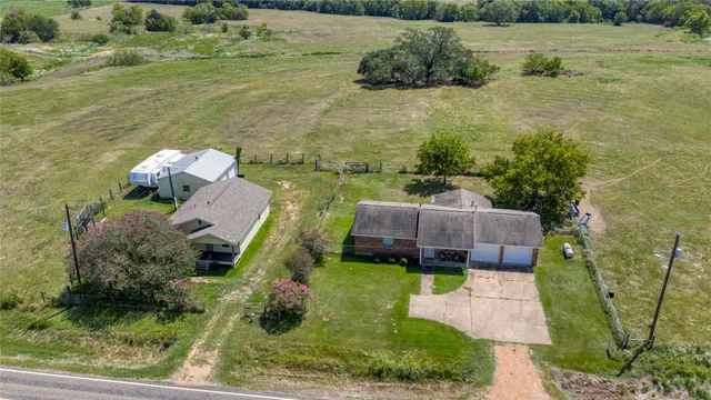 a aerial view of a house with a yard