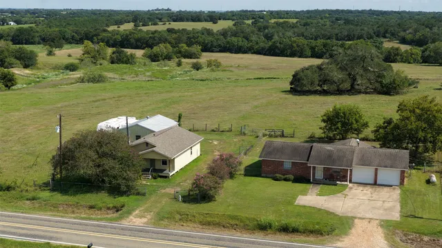 an aerial view of a house with a yard