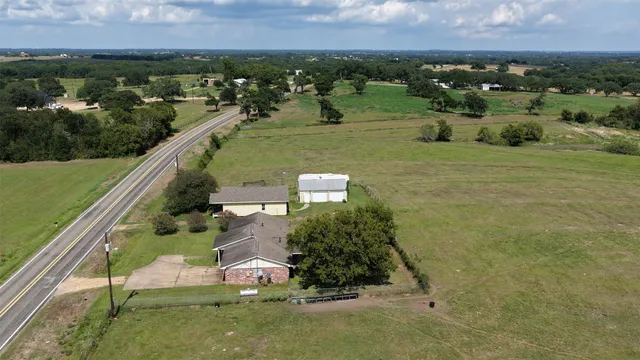 an aerial view of a house with a yard