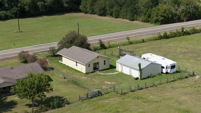 an aerial view of a house with outdoor space