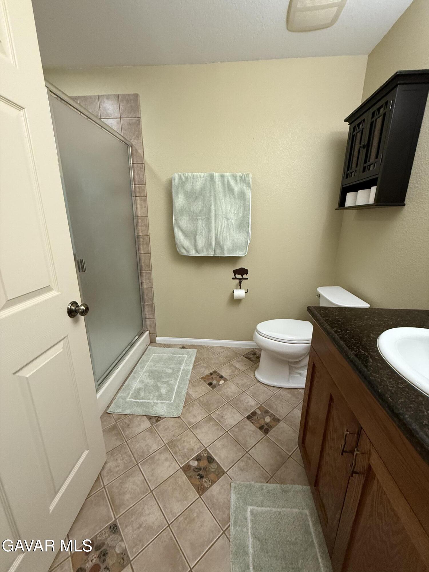28147 Lake Wohlford Road Valley Center, CA 92082 - Photo 11 of 25 a bathroom with a granite countertop sink toilet and shower