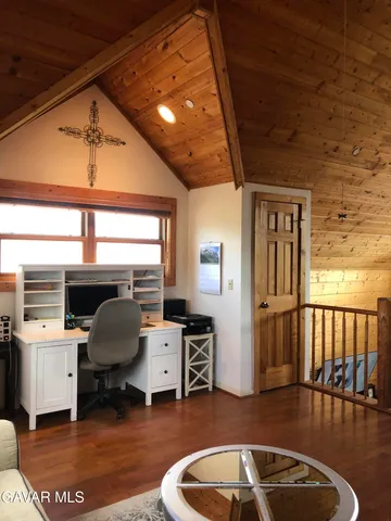 a spacious bedroom with a bed a couch and a window
