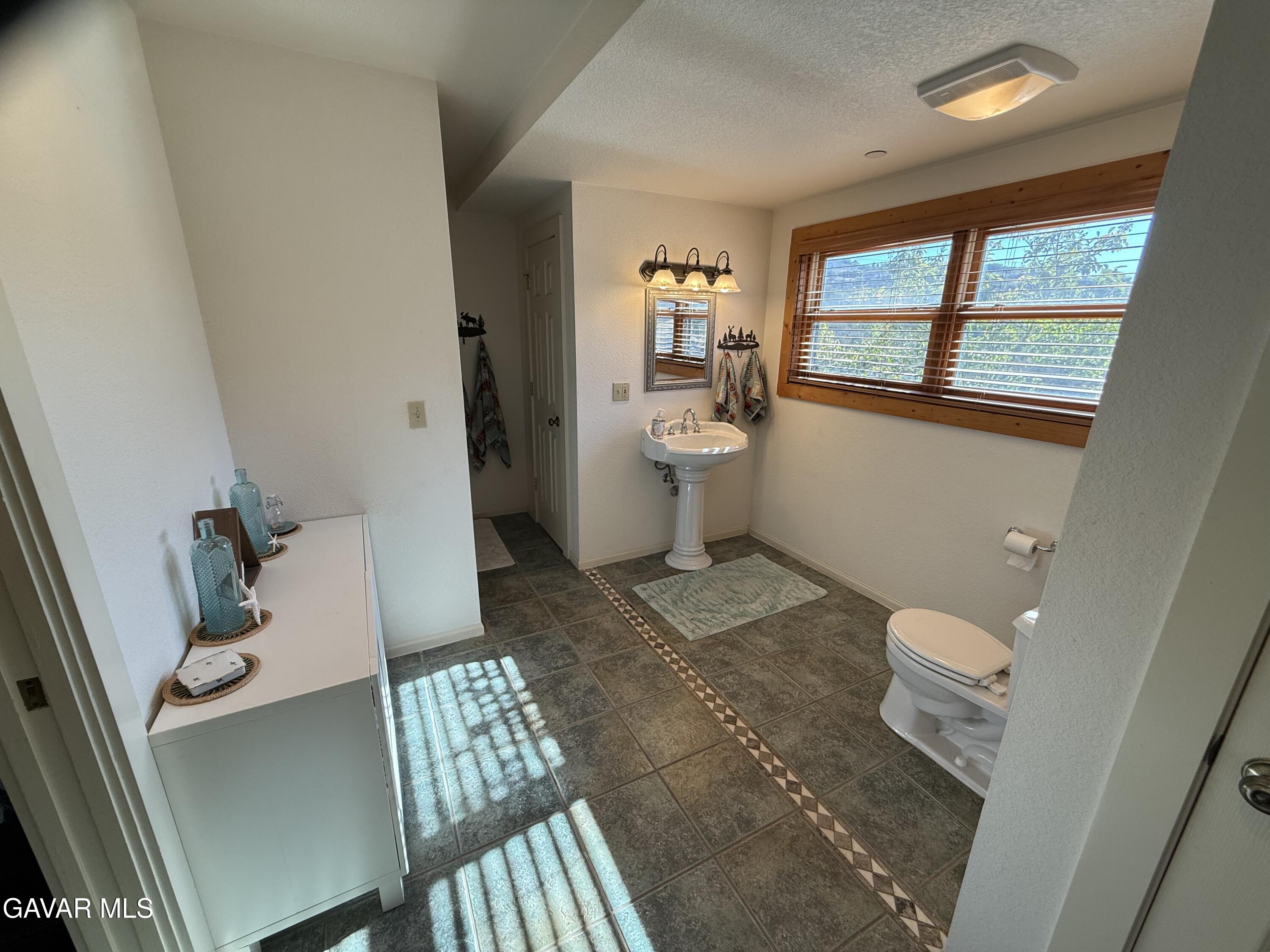 28147 Lake Wohlford Road Valley Center, CA 92082 - Photo 16 of 25 a bathroom with a sink and toilet