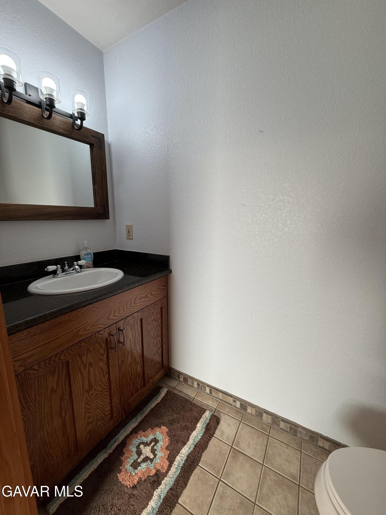 28147 Lake Wohlford Road Valley Center, CA 92082 - Photo 17 of 25 a bathroom with a sink and a mirror