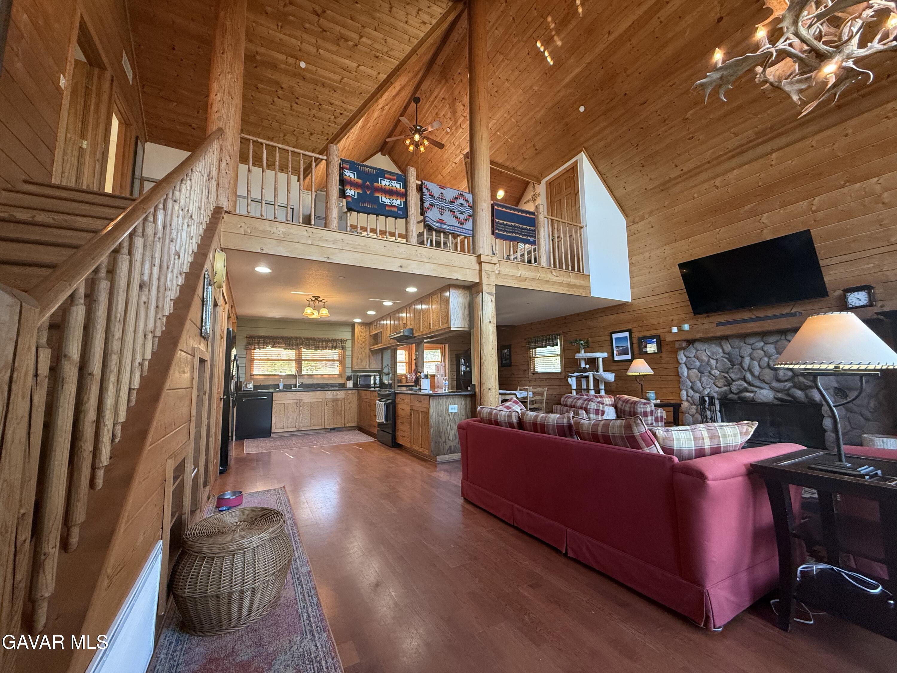 28147 Lake Wohlford Road Valley Center, CA 92082 - Photo 2 of 25 a living room with furniture a flat screen tv and a floor to ceiling window