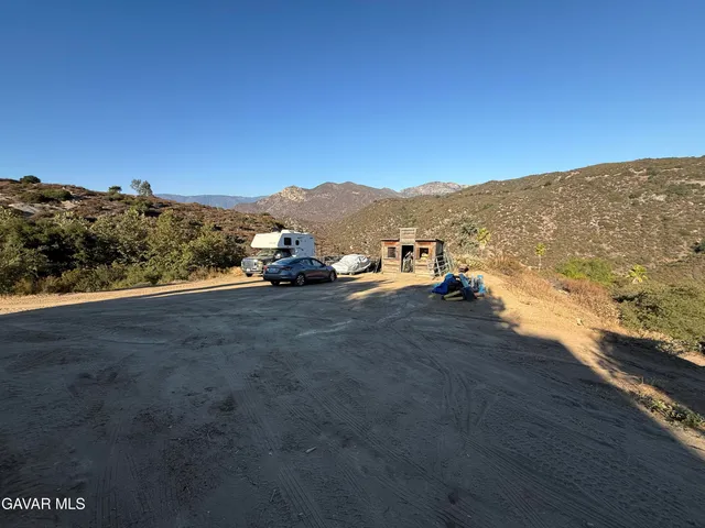 an aerial view of a house with a mountain