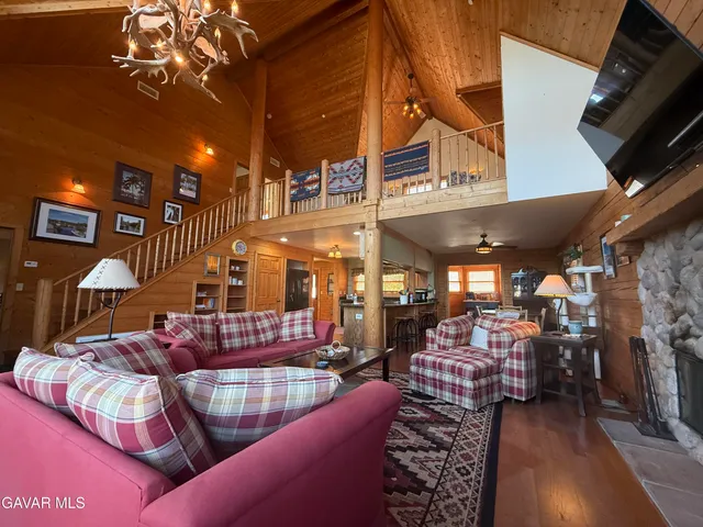 a bed room with a bed tv and a large window